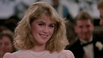 Movie still from “Pretty in Pink” (1986), directed by Howard Deutch – A person wearing a pink dress; Close Up shot, Over the shoulder angle