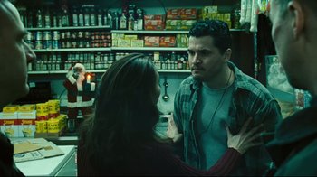 Movie still from “Pride and Glory” (2008), directed by Gavin O'Connor – A man and a woman are talking in a store; Medium shot, Over the shoulder angle