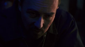 Movie still from “Pride and Glory” (2008), directed by Gavin O'Connor – A person wearing a necklace; Close Up shot, Low angle