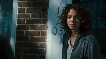 Movie still from “Pride and Glory” (2008), directed by Gavin O'Connor – A woman standing in front of a brick wall; Close Up shot, Low angle