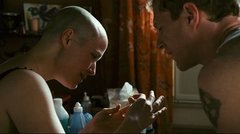 Movie still from “Pride and Glory” (2008), directed by Gavin O'Connor – A bald man and a bald woman are looking at each other; Close Up shot, Over the shoulder angle