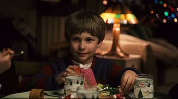 Movie still from “Pride and Glory” (2008), directed by Gavin O'Connor – A young boy sitting at a table with food in front of him; Close Up shot, High angle