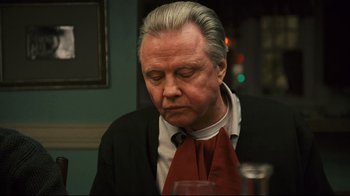 Movie still from “Pride and Glory” (2008), directed by Gavin O'Connor – An older man wearing a suit and red tie; Close Up shot, Over the shoulder angle