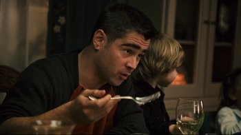 Movie still from “Pride and Glory” (2008), directed by Gavin O'Connor – A man holding a fork in his right hand while sitting at a dinner table; Close Up shot, Over the shoulder angle