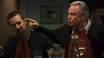 Movie still from “Pride and Glory” (2008), directed by Gavin O'Connor – A man pointing at something while sitting at a dinner table; Medium shot, Over the shoulder angle