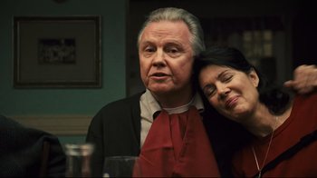 Movie still from “Pride and Glory” (2008), directed by Gavin O'Connor – An older man and a younger woman pose for a picture; Close Up shot, Low angle