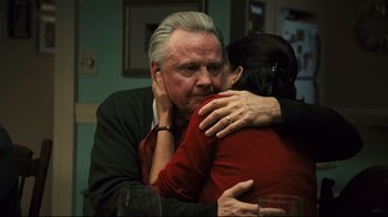 Movie still from “Pride and Glory” (2008), directed by Gavin O'Connor – An older man hugging a younger woman in a room; Close Up shot, Over the shoulder angle