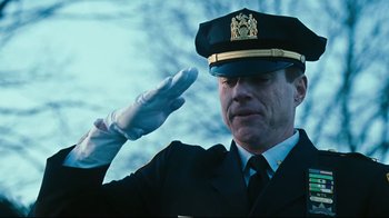 Movie still from “Pride and Glory” (2008), directed by Gavin O'Connor – A man in a uniform saluting with a white glove; Close Up shot, Low angle