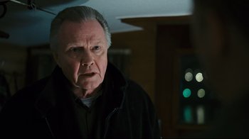 Movie still from “Pride and Glory” (2008), directed by Gavin O'Connor – An older man in a black jacket looking at the camera; Close Up shot, Over the shoulder angle