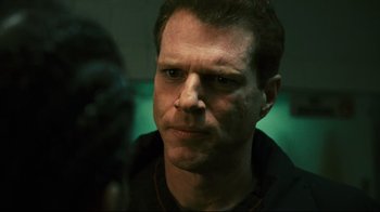 Movie still from “Pride and Glory” (2008), directed by Gavin O'Connor – A person wearing a black shirt; Close Up shot, Over the shoulder angle