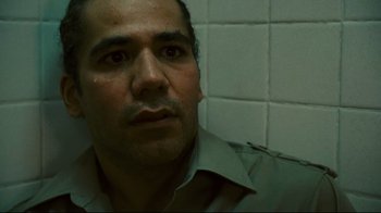 Movie still from “Pride and Glory” (2008), directed by Gavin O'Connor – A person in a room with tiled walls; Close Up shot, Low angle