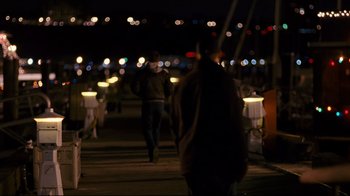 Movie still from “Pride and Glory” (2008), directed by Gavin O'Connor – A group of people walking down a sidewalk at night; Wide shot, Over the shoulder angle