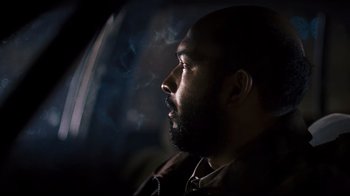 Movie still from “Pride and Glory” (2008), directed by Gavin O'Connor – A person looking out a window; Close Up shot, Low angle