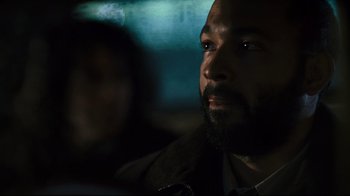 Movie still from “Pride and Glory” (2008), directed by Gavin O'Connor – A person with a beard looking at something; Close Up shot, Over the shoulder angle