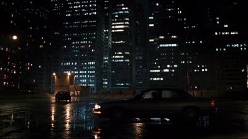 Movie still from “Pride and Glory” (2008), directed by Gavin O'Connor – A car driving down a street at night; Extreme Wide shot, High angle