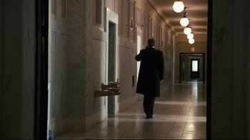 Movie still from “Pride and Glory” (2008), directed by Gavin O'Connor – A man walking down a hallway in a building; Wide shot, Low angle