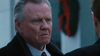 Movie still from “Pride and Glory” (2008), directed by Gavin O'Connor – An older man in a suit and tie looking to his left; Close Up shot, Low angle