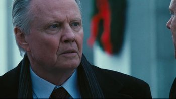 Movie still from “Pride and Glory” (2008), directed by Gavin O'Connor – An older man wearing a suit and tie looking to his left; Close Up shot, Over the shoulder angle