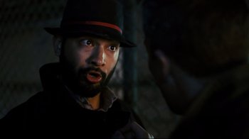 Movie still from “Pride and Glory” (2008), directed by Gavin O'Connor – A man with a beard wearing a black hat; Close Up shot, Over the shoulder angle