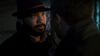 Movie still from “Pride and Glory” (2008), directed by Gavin O'Connor – A man wearing a black hat and a black jacket talking to another man; Close Up shot, Over the shoulder angle