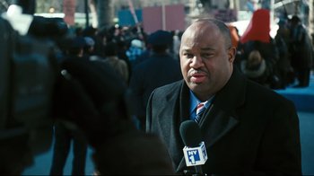 Movie still from “Pride and Glory” (2008), directed by Gavin O'Connor – A man is being interviewed by a tv reporter; Close Up shot, Over the shoulder angle