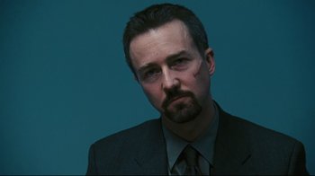 Movie still from “Pride and Glory” (2008), directed by Gavin O'Connor – A person wearing a suit and tie; Close Up shot, Low angle