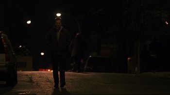 Movie still from “Pride and Glory” (2008), directed by Gavin O'Connor – A man standing on the side of a road at night; Wide shot, Low angle