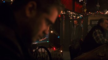 Movie still from “Pride and Glory” (2008), directed by Gavin O'Connor – A man standing next to a pool table in a room; Medium shot, Over the shoulder angle