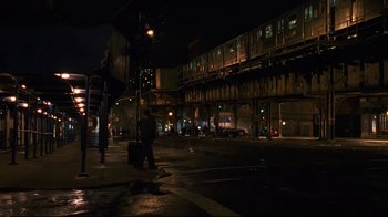 Movie still from “Pride and Glory” (2008), directed by Gavin O'Connor – A man walking down a street at night; Extreme Wide shot, High angle