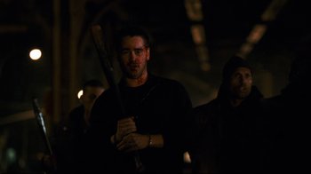 Movie still from “Pride and Glory” (2008), directed by Gavin O'Connor – A man holding a baseball bat while standing next to other men; Medium shot, Low angle