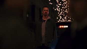 Movie still from “Pride and Glory” (2008), directed by Gavin O'Connor – A man standing in front of a street light at night; Medium shot, Over the shoulder angle