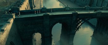 Movie still from “Pride and Prejudice and Zombies” (2016), directed by Burr Steers – People standing on the side of a bridge over a river; Extreme Wide shot, High angle