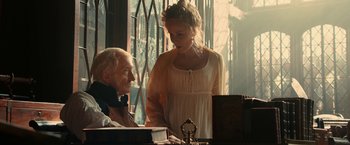 Movie still from “Pride and Prejudice and Zombies” (2016), directed by Burr Steers – An old man and a young woman standing next to each other; Medium shot, Over the shoulder angle