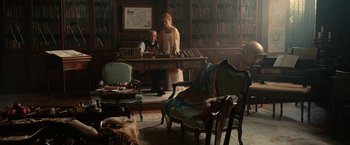 Movie still from “Pride and Prejudice and Zombies” (2016), directed by Burr Steers – A man and a woman standing in front of a desk; Wide shot, High angle