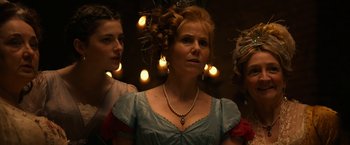 Movie still from “Pride and Prejudice and Zombies” (2016), directed by Burr Steers – A woman in a blue dress with two other women in the background; Close Up shot, Low angle
