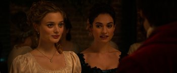 Movie still from “Pride and Prejudice and Zombies” (2016), directed by Burr Steers – Two young women standing next to each other in a room; Close Up shot, Over the shoulder angle