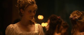 Movie still from “Pride and Prejudice and Zombies” (2016), directed by Burr Steers – A young woman standing next to another young woman; Close Up shot, Over the shoulder angle