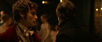 Movie still from “Pride and Prejudice and Zombies” (2016), directed by Burr Steers – Two men talking to each other in front of a crowd of onlookers; Close Up shot, Over the shoulder angle