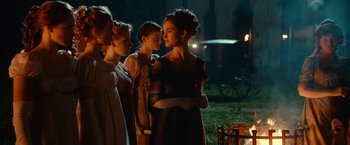 Movie still from “Pride and Prejudice and Zombies” (2016), directed by Burr Steers – A group of people standing next to each other in the dark; Medium shot, Over the shoulder angle