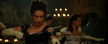 Movie still from “Pride and Prejudice and Zombies” (2016), directed by Burr Steers – A woman in a black dress holding a pair of chopsticks; Close Up shot, Over the shoulder angle
