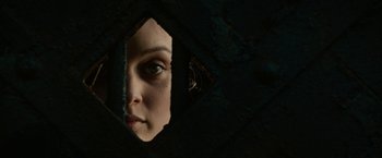 Movie still from “Pride and Prejudice and Zombies” (2016), directed by Burr Steers – A person looking through a hole in the wall; Extreme Close Up shot, Overhead angle
