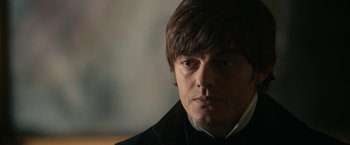 Movie still from “Pride and Prejudice and Zombies” (2016), directed by Burr Steers – A person wearing a jacket; Close Up shot, Over the shoulder angle