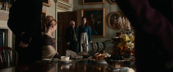 Movie still from “Pride and Prejudice and Zombies” (2016), directed by Burr Steers – A group of people standing around a table; Wide shot, Over the shoulder angle