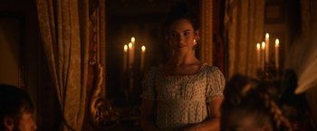 Movie still from “Pride and Prejudice and Zombies” (2016), directed by Burr Steers – A woman standing in front of a mirror in a room; Medium shot, Over the shoulder angle