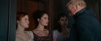 Movie still from “Pride and Prejudice and Zombies” (2016), directed by Burr Steers – Two women are standing next to each other in a room; Close Up shot, Over the shoulder angle