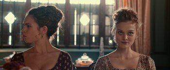 Movie still from “Pride and Prejudice and Zombies” (2016), directed by Burr Steers – Two women standing next to each other in front of a window; Close Up shot, Over the shoulder angle