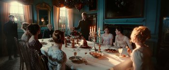 Movie still from “Pride and Prejudice and Zombies” (2016), directed by Burr Steers – A group of people sitting around a dinner table; Wide shot, High angle