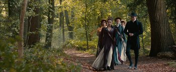 Movie still from “Pride and Prejudice and Zombies” (2016), directed by Burr Steers – A group of people walking through the woods; Wide shot, High angle