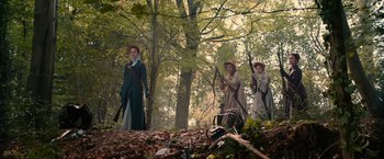 Movie still from “Pride and Prejudice and Zombies” (2016), directed by Burr Steers – A group of people standing next to each other in the woods; Wide shot, Low angle