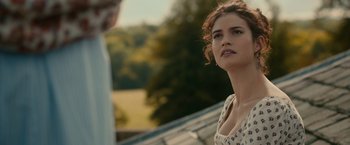Movie still from “Pride and Prejudice and Zombies” (2016), directed by Burr Steers – A woman standing next to another woman on a roof; Close Up shot, Over the shoulder angle